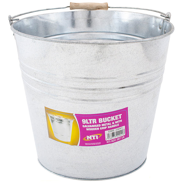 The Galvanised Metal Bucket 9l is shown, perfect for gardening or DIY projects. It features a wooden grip handle and has a purple label that reads "9LTR BUCKET" and "Galvanised Metal & Wooden Grip Handle," along with a barcode and additional text. The bucket also sports a ribbed design near the top.
