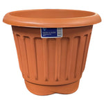 A large, round, terracotta-colored plastic planter featuring vertical ridges and a small label near the top that reads "Round Ribbed Plastic Planter Terracotta 30cm," this weather-resistant plant pot is perfect for your outdoor garden space.