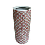 The Red and White Daisy Chain Umbrella Stand is a tall, cylindrical ceramic piece with a smooth finish, featuring a bold geometric red lattice pattern on white—perfect as a striking hallway umbrella holder.