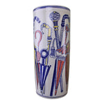 A tall cylindrical ceramic umbrella stand named "Umbrella Stand, Pastel Coloured Umbrellas Design," decorated with pastel umbrella motifs and walking sticks in blue, red, yellow, and gold on a white background.