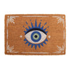 This whimsical home accent, the Natural All Seeing Eye Doormat, features a striking blue iris with radiating blue spikes on a natural brown coir background and white corner designs.
