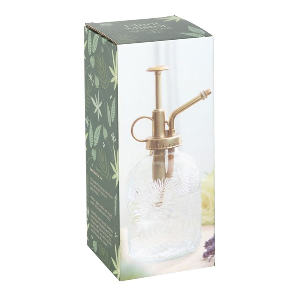 A Large Leaf Print Glass Plant Mister in its packaging. The box features a green floral design and displays an image of the mister, which showcases a brass-colored pump and textured glass with etched leaf patterns, perfect for enhancing your indoor garden.