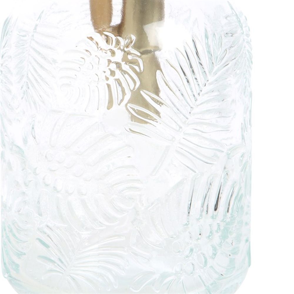 Close-up of a Large Leaf Print Glass Plant Mister, showcasing embossed patterns of tropical leaves and flowers on a textured glass jar. The design offers a rich, tactile appearance and provides a peek at the plant mister inside, making it ideal for enhancing your indoor garden.
