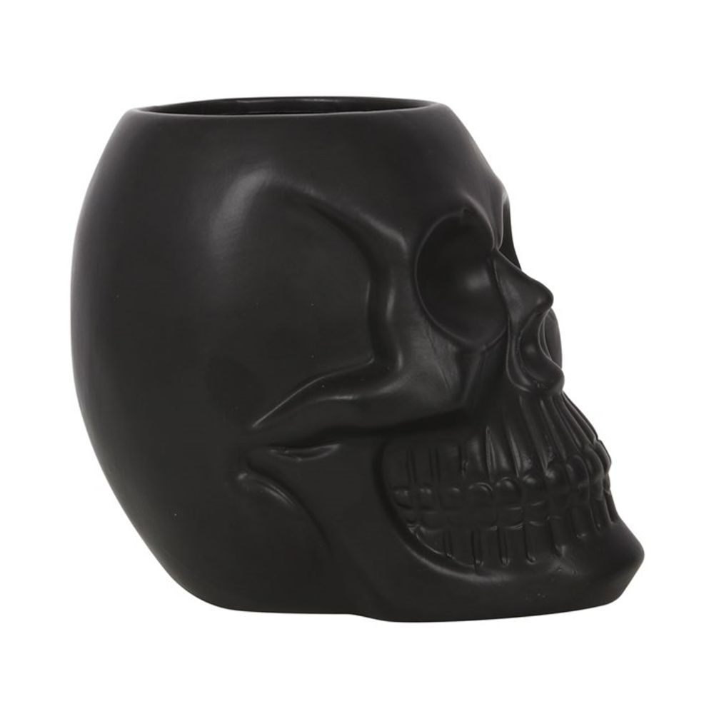 A Black Skull Plant Pot shaped like a human skull, viewed from the side. The design highlights detailed facial features, including sunken eye sockets, a pronounced brow, and a toothy grin, giving it a spooky and gothic appearance—perfect for haunted house plants.