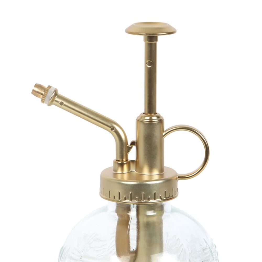 Introducing the Large Leaf Print Glass Plant Mister: Featuring a textured glass bottle with etched leaf designs and a gold metal pump and nozzle, complete with a circular handle. This elegant mister is perfect for adding both style and functionality to your indoor garden.