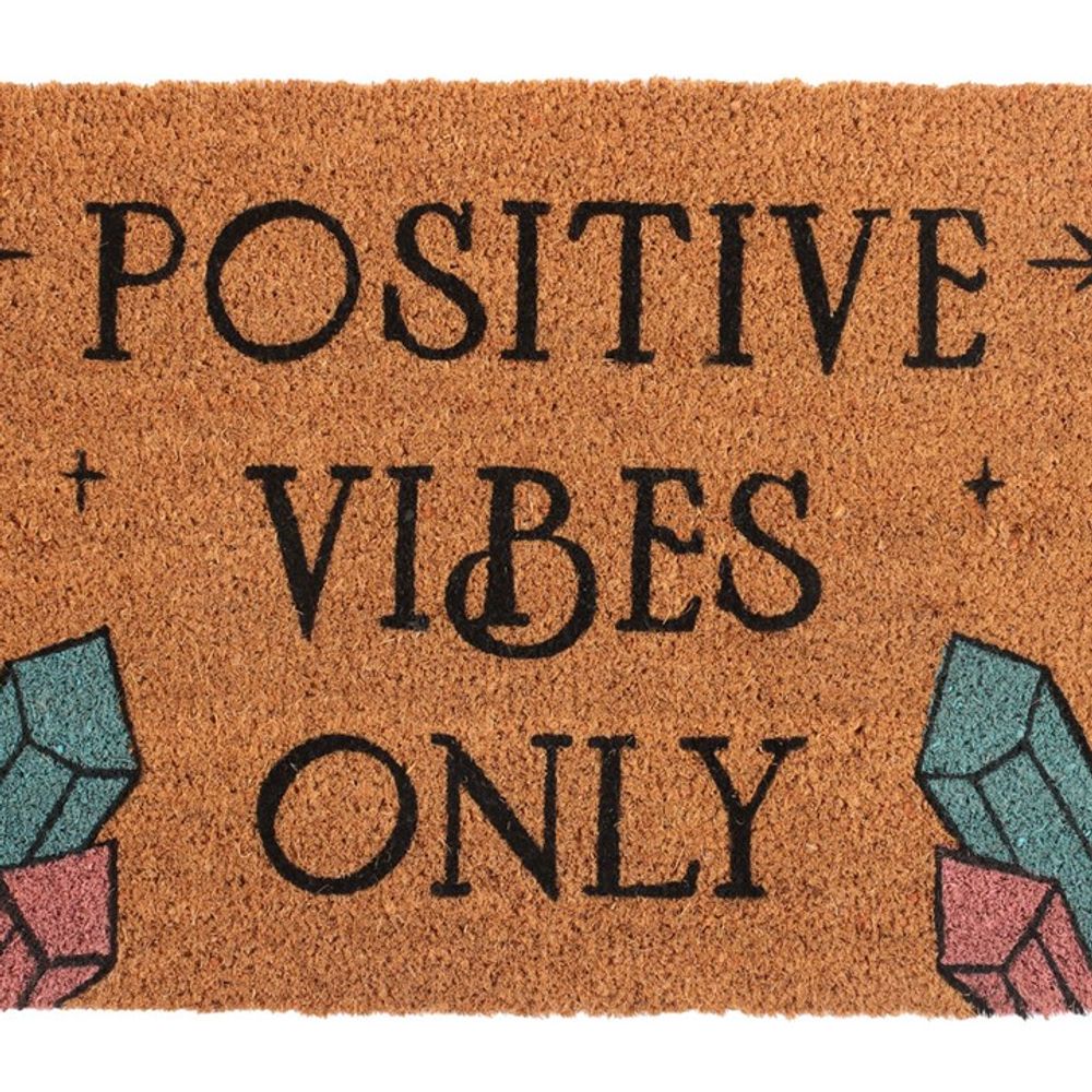 The Natural Positive Vibes Only Doormat features a light brown background with bold black "Positive Vibes Only" text. Each corner is adorned with vibrant, geometric illustrations of magic crystals, spreading love and happiness as you step inside.