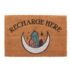 The Natural Recharge Here Crystal Doormat showcases the words "Recharge Here" in black on a brown backdrop. A mystical moon cradles vibrant crystals among scattered stars, adding both energy and style to any entrance.