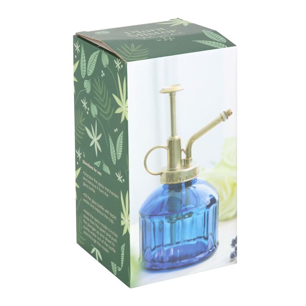 A decorative box perfect for the indoor garden enthusiast, featuring a vintage feel with the Small Blue Glass Plant Mister, complete with a gold-colored pump and nozzle. Set against green leaves and white branches, the box's sides boast charming text and leaf designs.