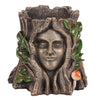 This sculpted planter, "The Green Goddess Plant Pot," resembles a tree trunk with a serene human face, featuring green leaves and a red-and-white mushroom for a whimsical, nature-inspired garden touch. Perfect for housing your beloved Green Goddess plant.