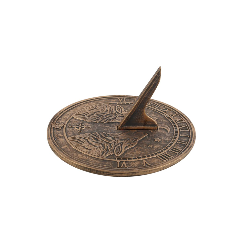 The Howling Wolves Terracotta Sundial by Lisa Parker, influenced by vintage artistry, showcases engraved wolf imagery and Roman numerals. The gnomon casts a shadow to indicate time, elegantly displayed on a smooth white surface.