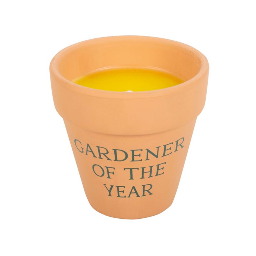 The Gardener of the Year Citronella Candle features vibrant yellow citronella wax in a rustic terracotta pot with elegant script, offering a lovely contrast for any ceramic plant pot display.
