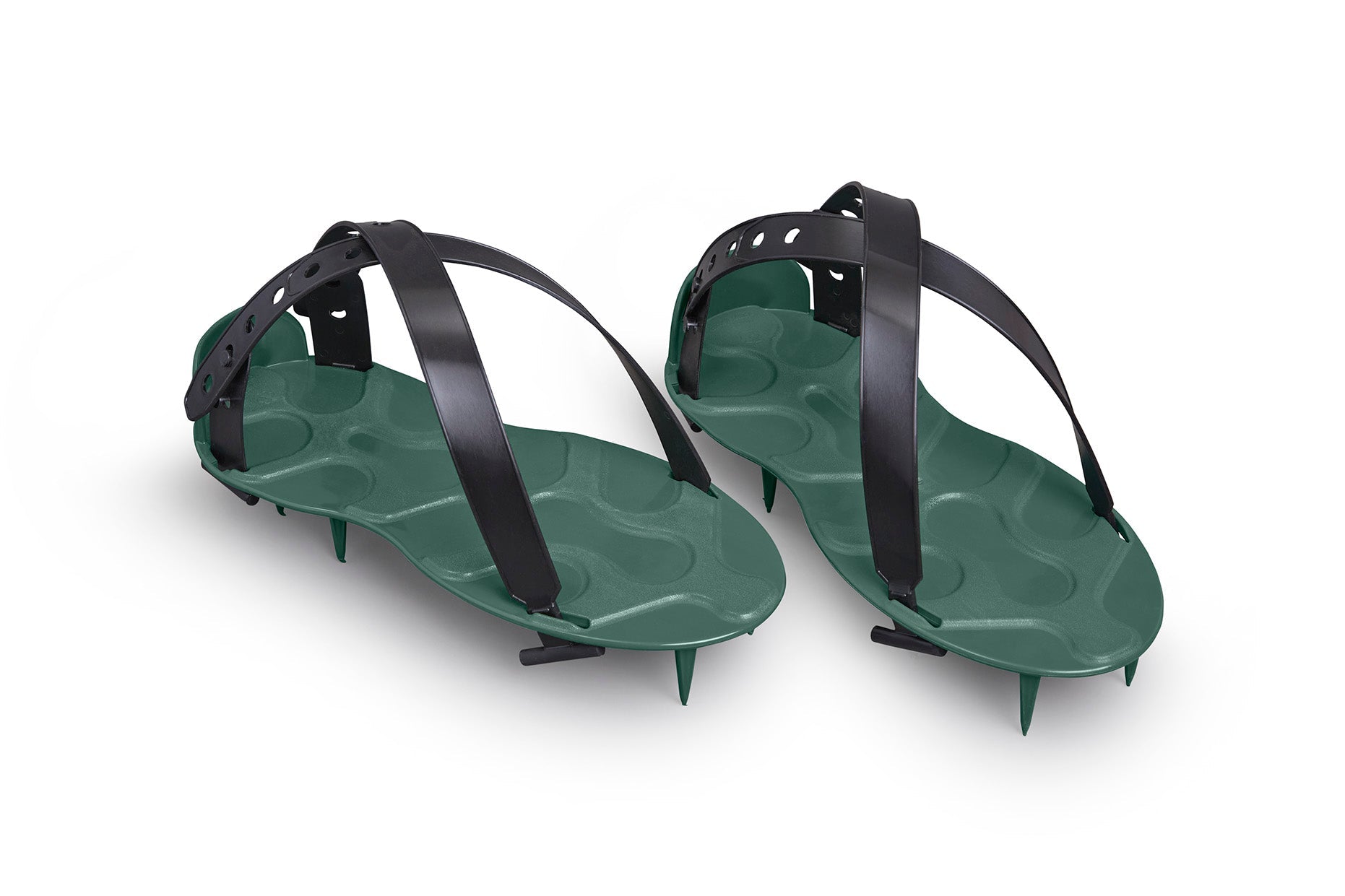 A pair of ProSpike Lawn Aerator Shoes featuring an enhanced strap design and four cross-shaped spikes on the soles. The black plastic adjustable straps ensure a secure fit over regular shoes, allowing the user to effortlessly aerate their lawn by walking on it.