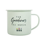 The Gardener's Tea Break Enamel Mug is a light green mug adorned with the phrase "The Gardener's Tea Break," making it ideal for avid gardeners. Below the text, three small botanical illustrations of flower pots add a delightful charm. The mug includes a simple handle on the right side.