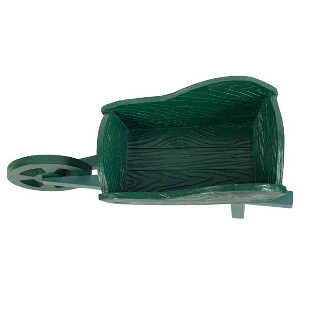 The Green Resin Wheelbarrow Planter, viewed from above, makes an appealing garden accessory. Its design features one wheel and a support leg, perfect for creative garden displays.