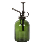 Introducing the Green Minimalist Glass Plant Mister, an ideal addition to your indoor garden. With a moss green glass body and a sleek metal pump and spout, this mister features a vintage-style design, complete with a brass-colored nozzle and handle for gentle plant care.