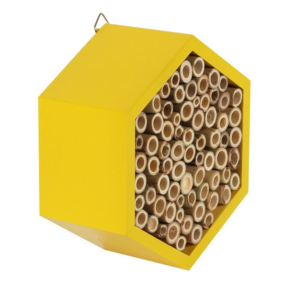 The Wooden Bee House is a hexagonal yellow bee hotel with wooden tubes in the front panel, ideal for attracting solitary pollinators. It enhances your garden and includes a top hook for easy hanging.
