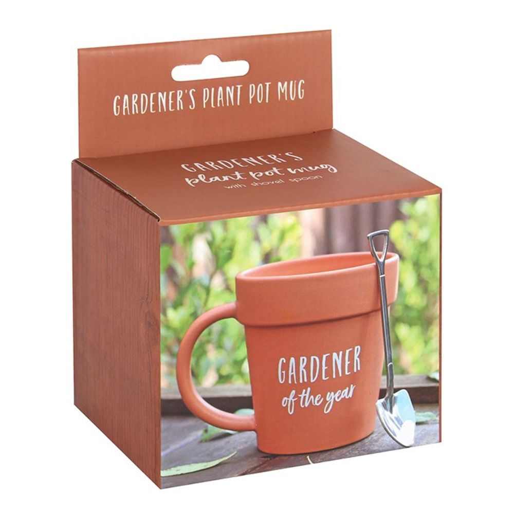 The Gardener of the Year Pot Mug and Shovel Spoon set comes in a brown box, featuring a ceramic mug styled as a terracotta plant pot and labeled "Gardener of the Year," along with a mini shovel-shaped teaspoon. Perfectly packaged to delight any green thumb.