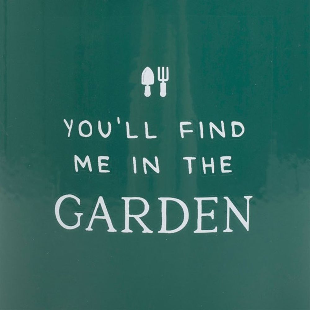 The Find Me in the Garden Enamel Mug features a green background with "YOU'LL FIND ME IN THE GARDEN" text in white, topped with small icons of a garden trowel and fork. Ideal for garden enthusiasts dreaming of their next forest green mug.