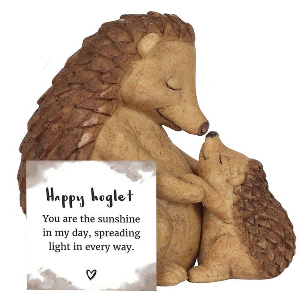 The Happy Hoglet Mother and Baby Hedgehog Ornament features a mother and baby hedgehog embracing with closed eyes, exuding affection. Accompanied by a sign saying, "Happy hoglet. You are the sunshine in my day, spreading light in every way," with a heart below—a perfect gift for loved ones.