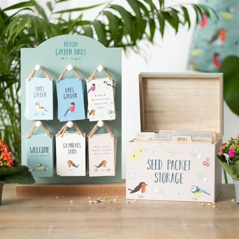 Explore bird-themed garden signs with messages like "This Way," "Dad's Garden," and more, plus the British Garden Birds Seed Packet Storage Box adorned with bird and flower designs—perfect gifts for gardeners.