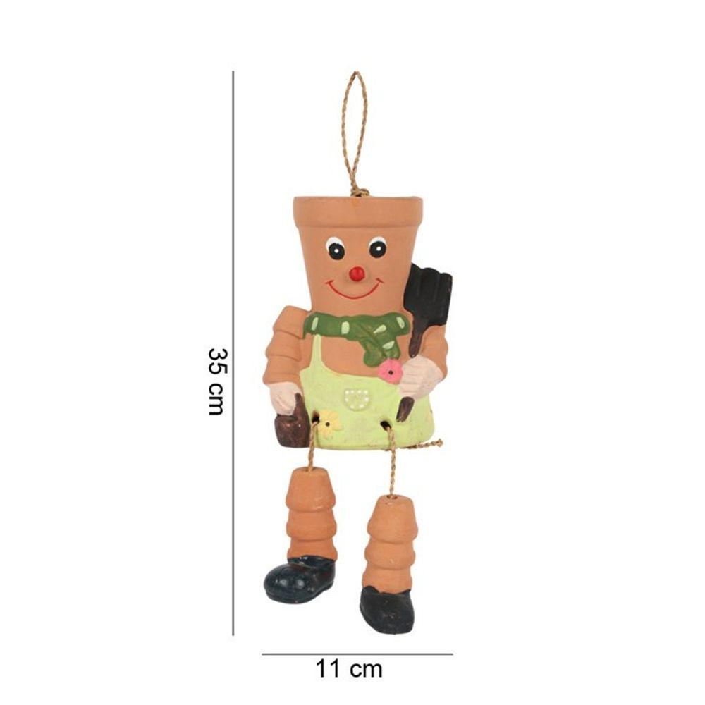 The Terracotta Pot Man Planter is a decorative clay figurine with a painted face, green scarf, botanical hairstyle, jointed limbs, black boots, and a gardening tool. Ideal for garden decor, it measures 35 cm in height and 11 cm in width.