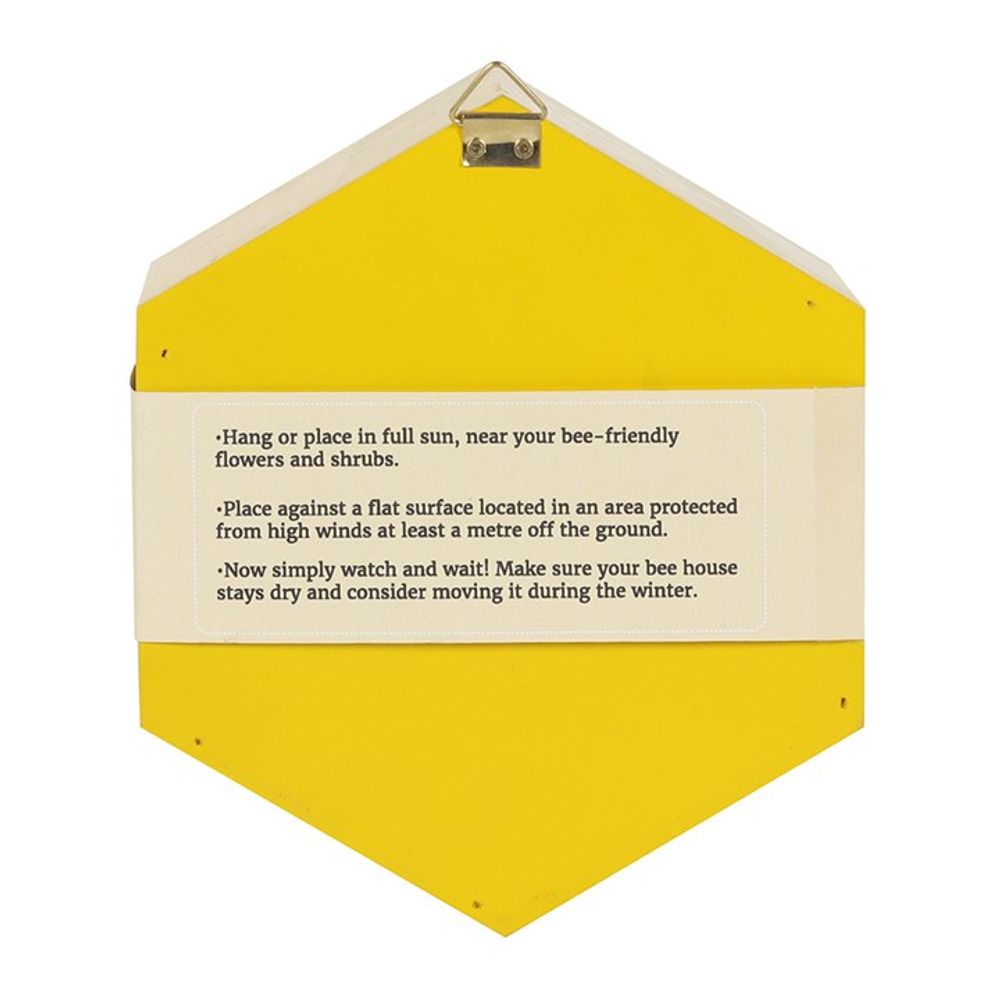 The Wooden Bee House, shaped like a triangle with a white strip of printed instructions, is perfect for garden sanctuaries. Hang in full sun near pollinator-friendly flowers, place on a flat surface sheltered from wind, and check dryness often, especially in winter.