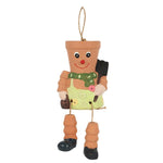 The Terracotta Pot Man Planter brings charm to any garden decor with its smiling face, botanical hairstyle, green scarf, and yellow apron. It has jointed arms and legs featuring black shoes and holds a miniature shovel. Ideal for hanging in your outdoor space using its attached string.