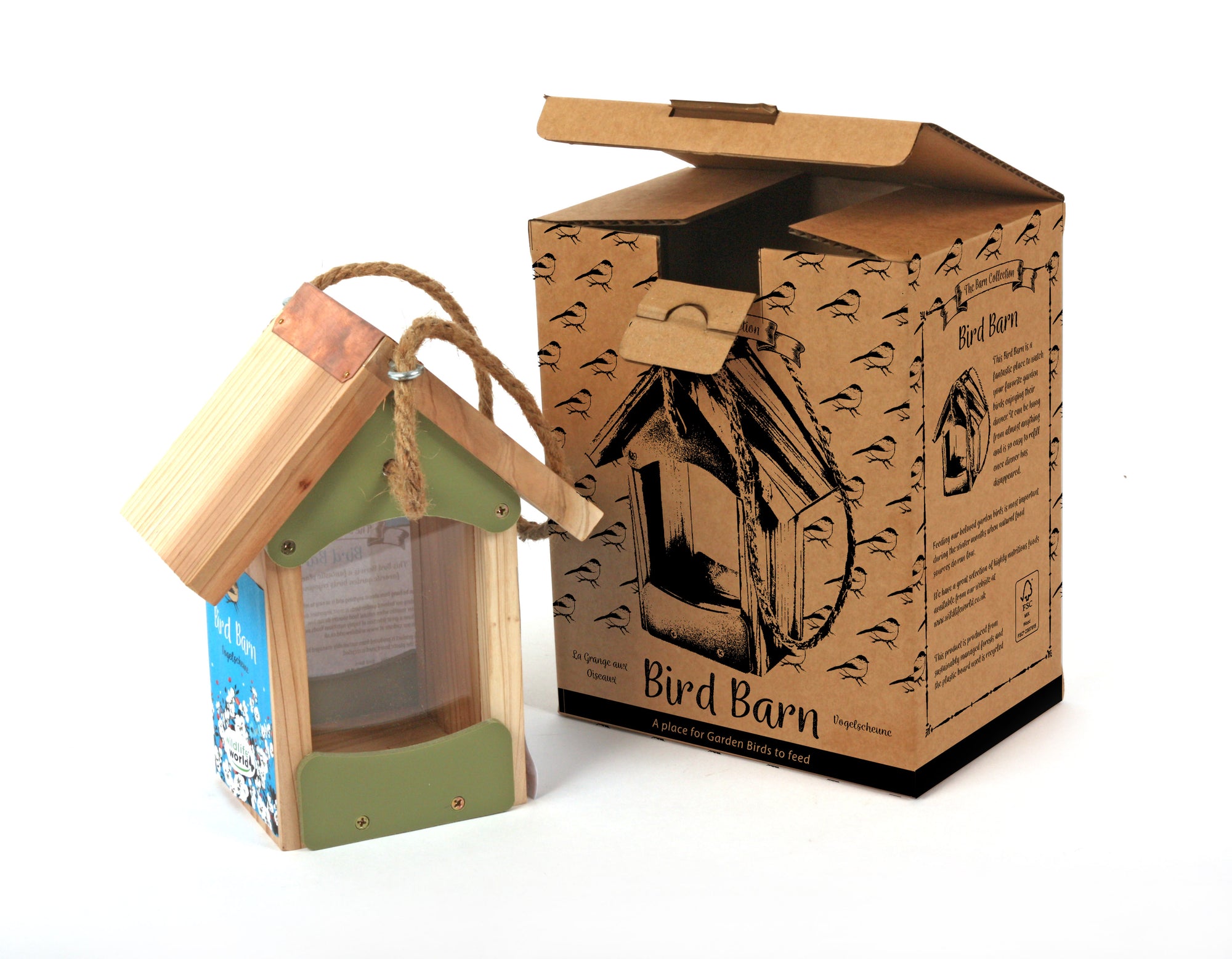 A Wildlife World Bird Barn - Bird Feeder, featuring a small wooden design with a clear plastic panel and a rope loop for hanging, is displayed beside a brown cardboard box embellished with bird illustrations and the "Bird Barn" text. Ideal for garden birds, this eco-friendly set has the box partially open, showcasing its contents inside.