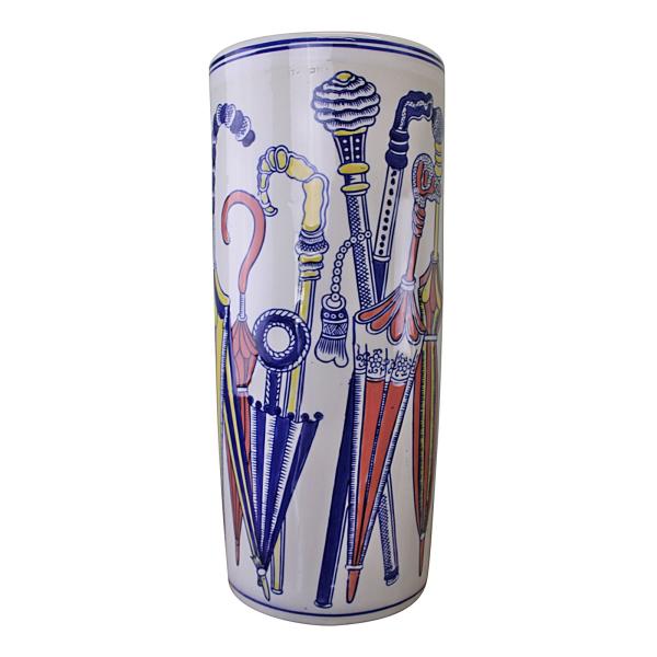 A tall cylindrical ceramic umbrella stand named "Umbrella Stand, Pastel Coloured Umbrellas Design," decorated with pastel umbrella motifs and walking sticks in blue, red, yellow, and gold on a white background.