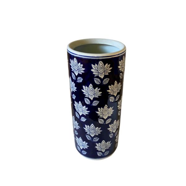 The Blue With White Flower Umbrella Stand features a tall, cylindrical ceramic design with a dark blue background and white floral patterns—ideal as a stylish hallway umbrella holder.