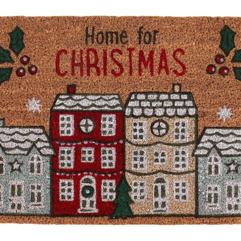 The Natural Home For Christmas Doormat showcases the text "Home for Christmas" at the top, accompanied by a delightful Christmas village design. This festive mat is adorned with vibrant illustrations of snow-covered houses, holiday decorations, holly, and snowflakes to enrich its holiday spirit.