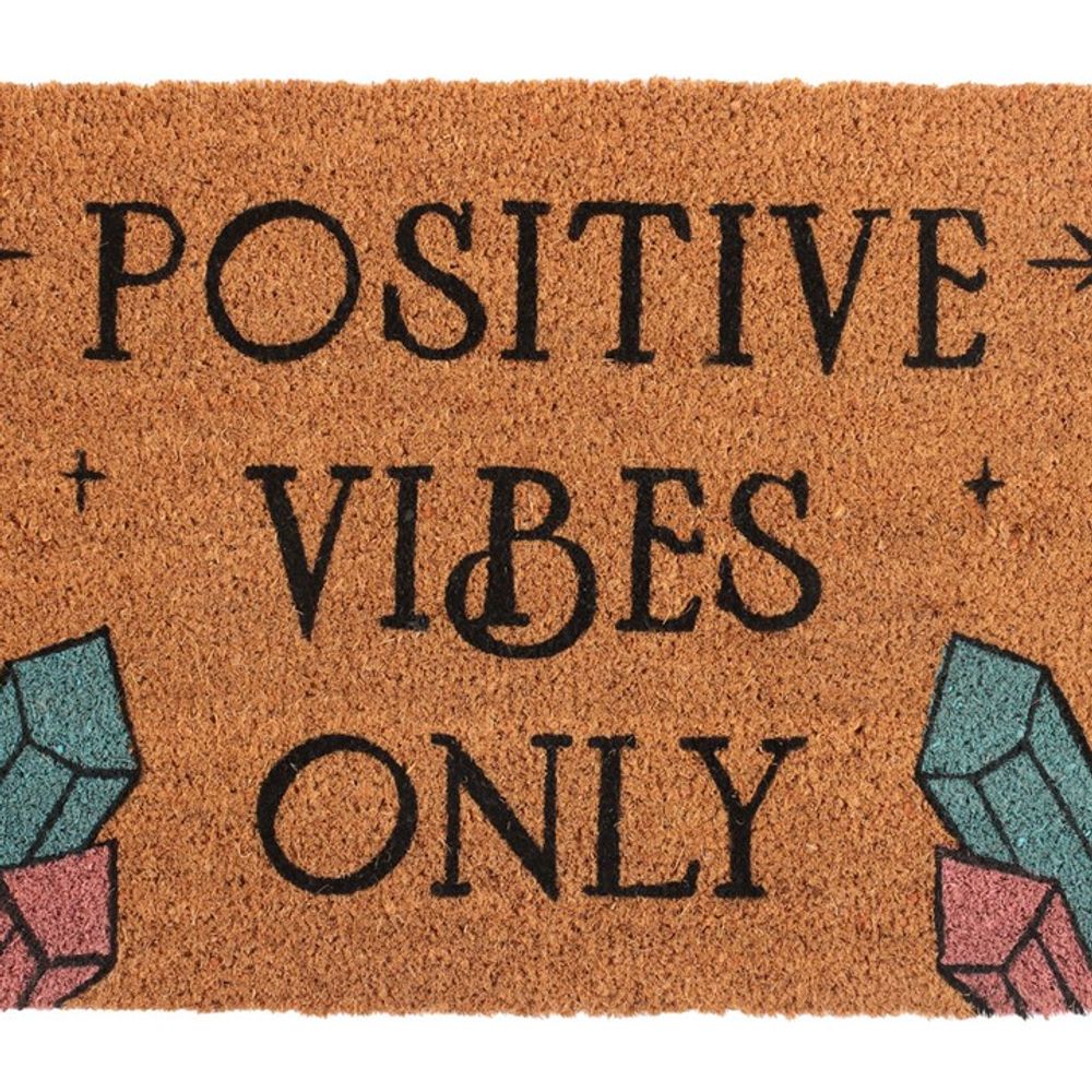 The Natural Positive Vibes Only Doormat features a light brown background with bold black "Positive Vibes Only" text. Each corner is adorned with vibrant, geometric illustrations of magic crystals, spreading love and happiness as you step inside.