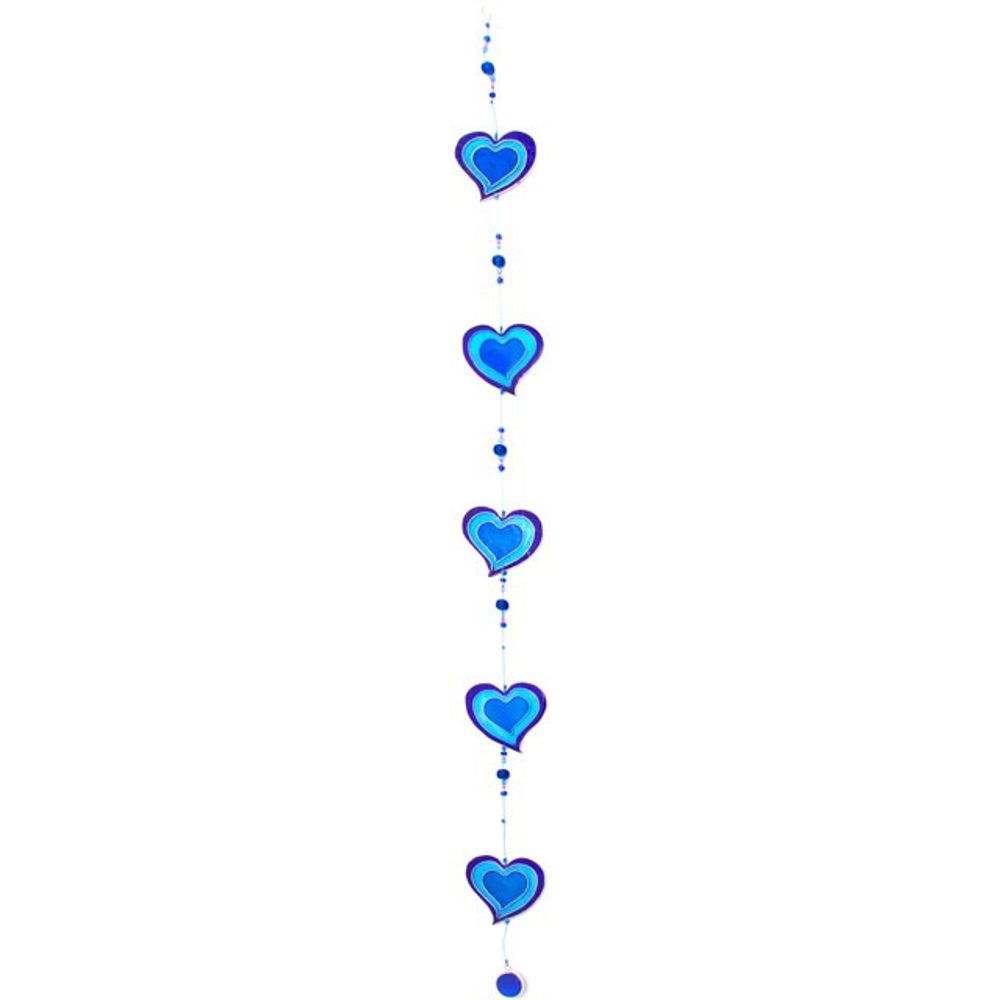 The Purple & Blue String Of Hearts suncatcher showcases a vertical arrangement of blue heart-shaped ornaments outlined in a deeper shade of blue. Ethically sourced beads are placed between the hearts, making it an eye-catching addition to window decor against a white background.