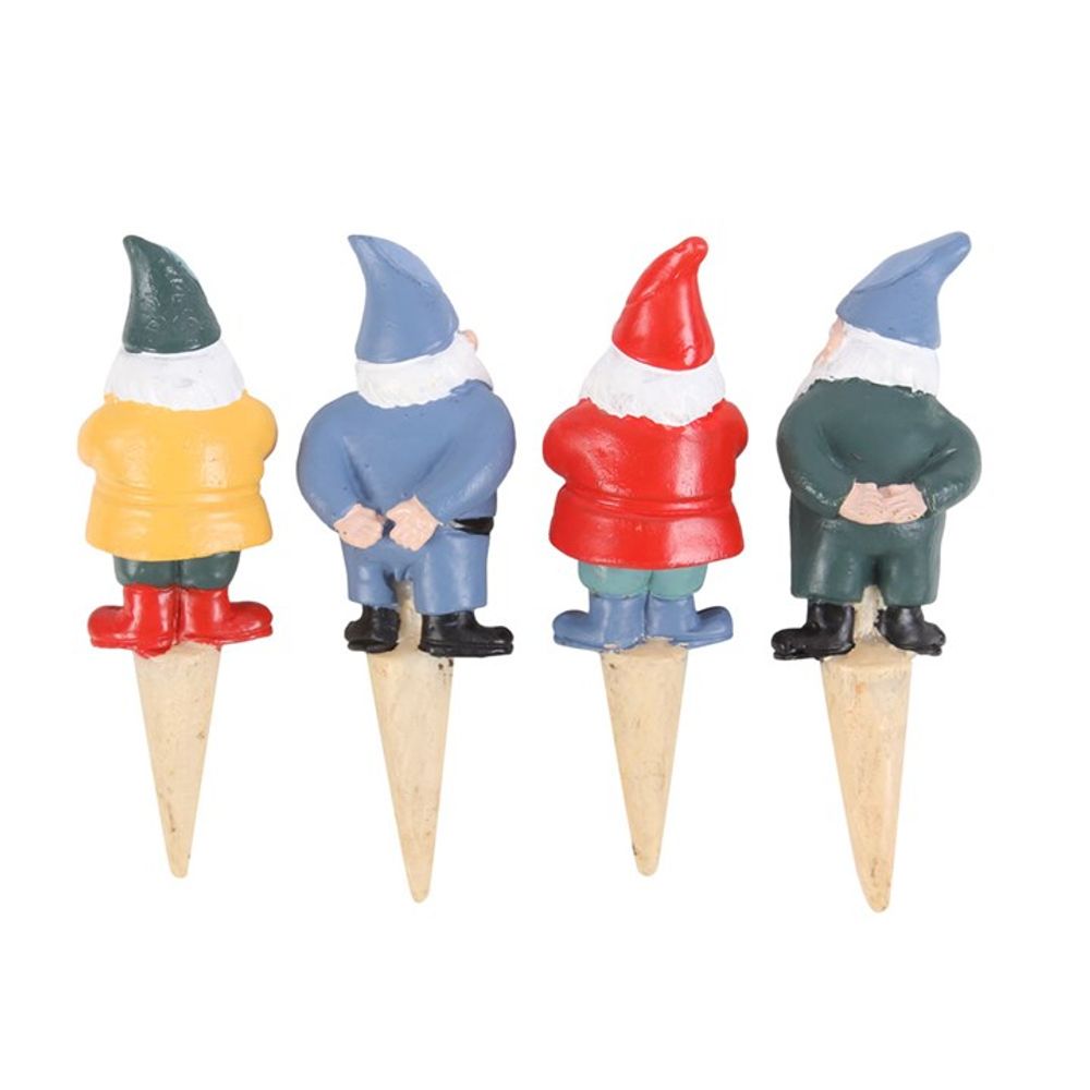 The Set of 4 Mini Gnome Plant Pot Pals features colorful gnomes with yellow, blue, red, and green outfits. Mounted on wooden stakes, these whimsical garden accessories showcase pointed hats and bushy white beards in a fairy garden setting.