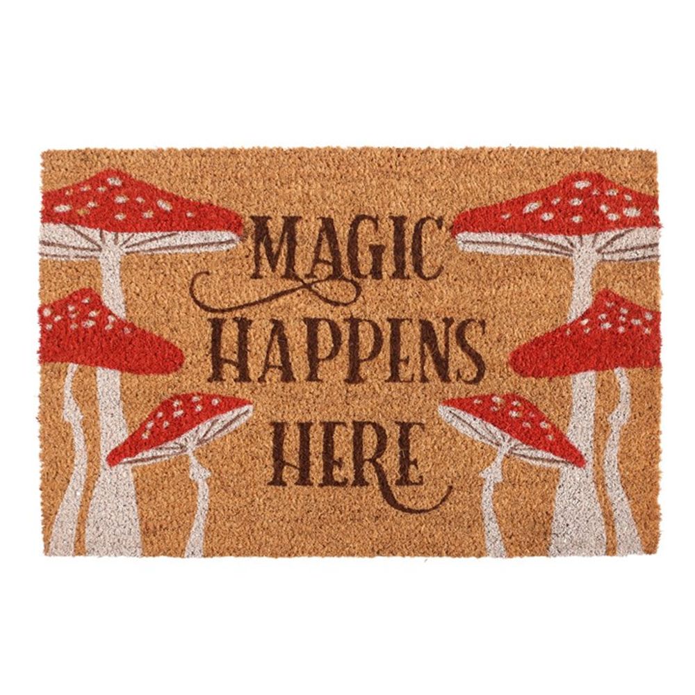 The Natural Magic Happens Here Mushroom Doormat displays "MAGIC HAPPENS HERE" amid red and white mushrooms on natural brown coir, offering a magical touch.