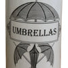 The Monochrome Ceramic Umbrella Stand with Umbrella Print features a vintage aesthetic with an illustration of two crossed umbrellas beneath a larger open one, all framed by ornate borders and the word "UMBRELLAS." This glazed ceramic stick stand exudes a timeless yet contemporary charm.
