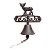 The Rustic Cast Iron Wall Bell, Reindeer Standing, is a decorative wall-mounted bell with a detailed reindeer design on top. It features intricate scrollwork and includes a hanging pull cord for easy ringing.