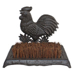 The Cast Iron Garden Boot Brush with a cockerel design features stiff natural fibre bristles on a rectangular base. Ornate detailing and the cast iron rooster add an elegant touch while efficiently cleaning shoe soles.