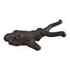 A bronze-colored, textured cast iron boot jack in a dog design, resembling a reclining animal with prominent horns. Its legs are tucked under its body, and the surface appears aged or weathered, making it perfect for outdoor use.