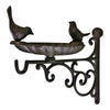 A beautifully designed cast iron wall-mounted bird feeder featuring ornate scroll designs and two bird figurines perched on the edge of its shallow basin, it serves as both a decorative piece and a practical addition to attract birds.