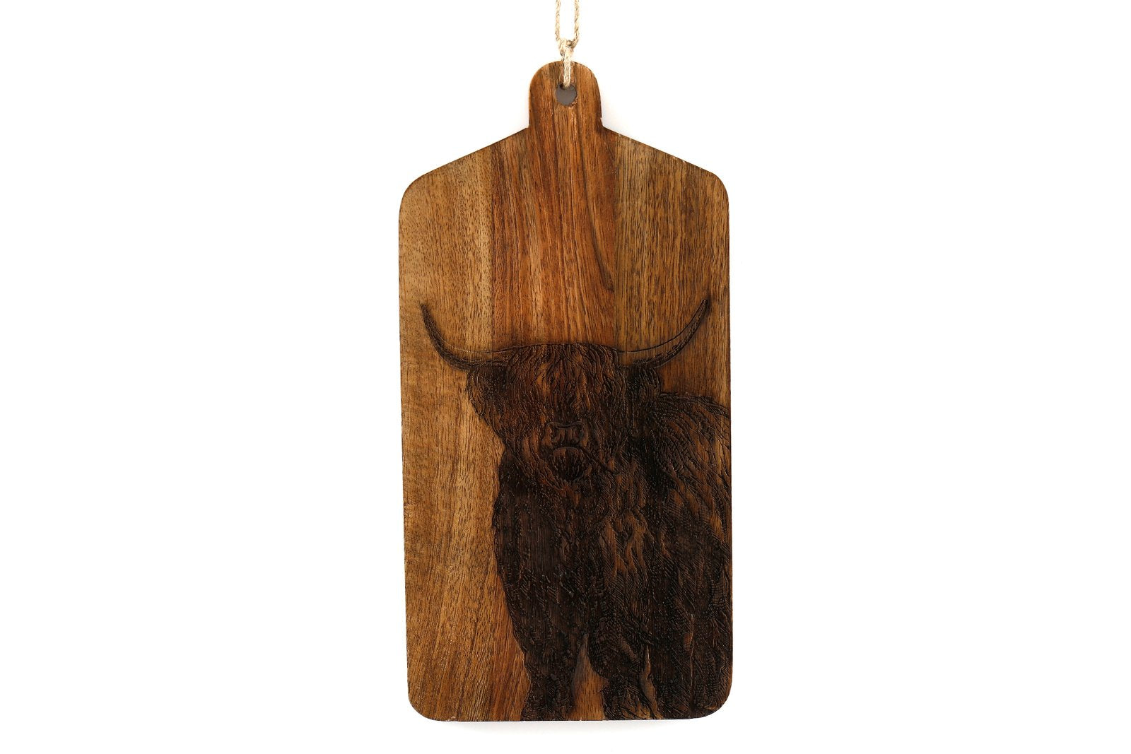 The Highland Cow Engraved Wooden Cheese Board is a rectangular mango wood cutting board with a handle, showcasing an intricately engraved portrait of a Highland cow with long horns and shaggy fur. The board can be conveniently hung by the loop of twine attached to the handle.