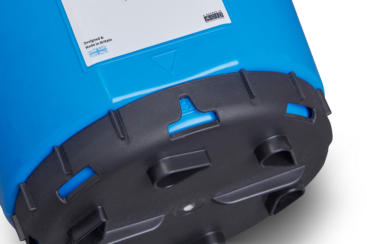 Close-up view of the bottom of the Winter Plastic Twist & Shake Salt Spreader in blue, featuring a black base. The spreader, with a 5KG capacity and 10 adjustable flow rates, has a label at the top that reads "Designed & Made in Britain" alongside a British flag. The black base includes several openings and displays a large number "3".