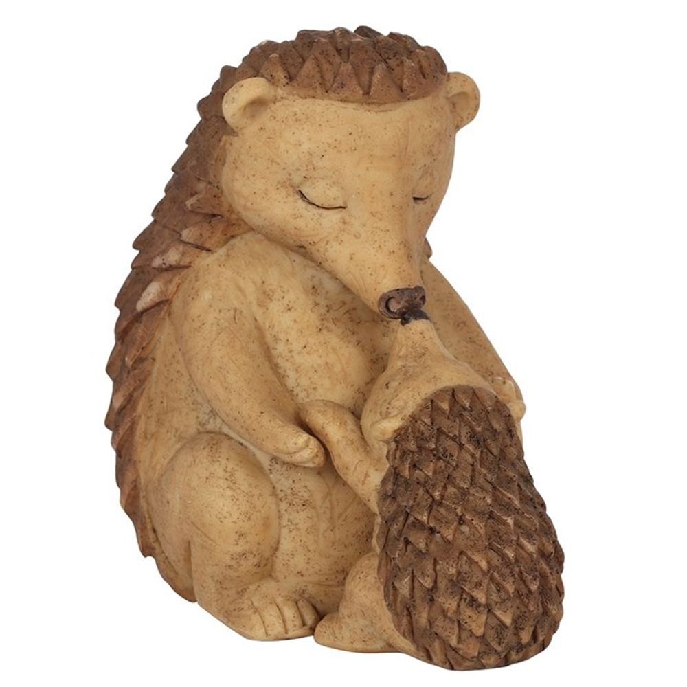 The Happy Hoglet Mother and Baby Hedgehog Ornament features a wooden sculpture of a mother and baby hedgehog touching noses, with closed eyes and textured spikes. Varying shades of brown give it a natural look, making it a charming, heartfelt gift.