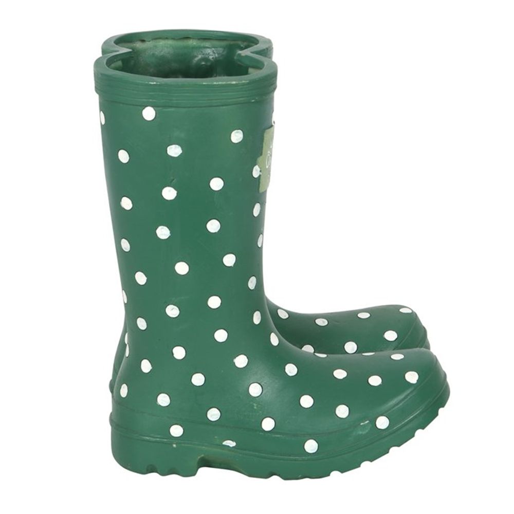 The Dark Green Welly Boot Planter, adorned with white polka dots, stands upright against a plain background and doubles as charming garden decor that brings a playful touch to any outdoor space.