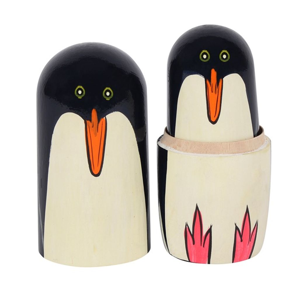 The Penguin Russian Doll makes for a delightful home ornament with handpainted wooden figures that showcase black heads, orange beaks, white bellies, and pink feet. The set includes one fully closed figure and others that open to reveal smaller pieces inside.