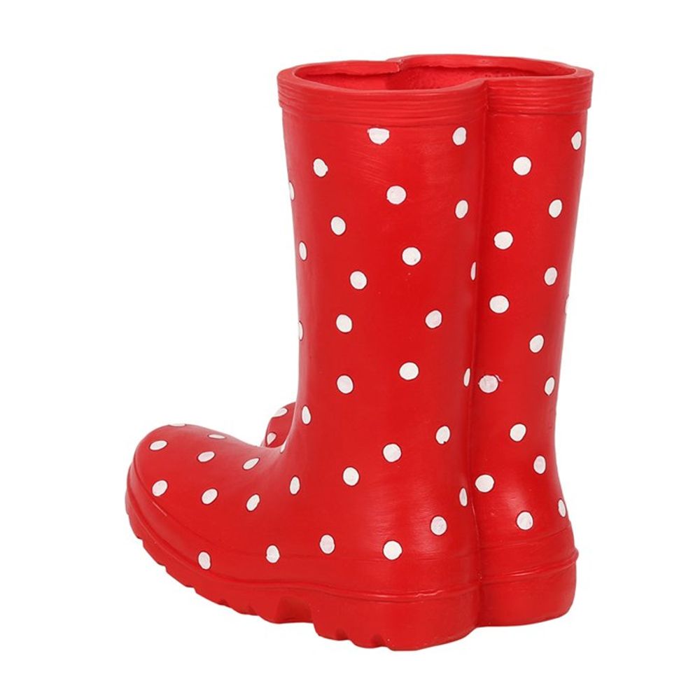 A Red Welly Boot Planter featuring white polka dots stands side by side on a white background, perfect for adding a whimsical touch to your garden.