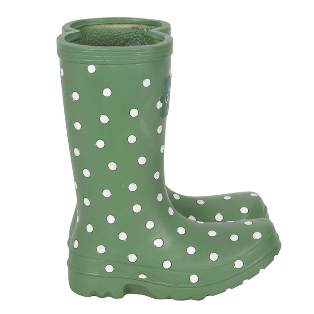 A Light Green Welly Boot Planter with white polka dots stands upright like a charming entrance piece.
