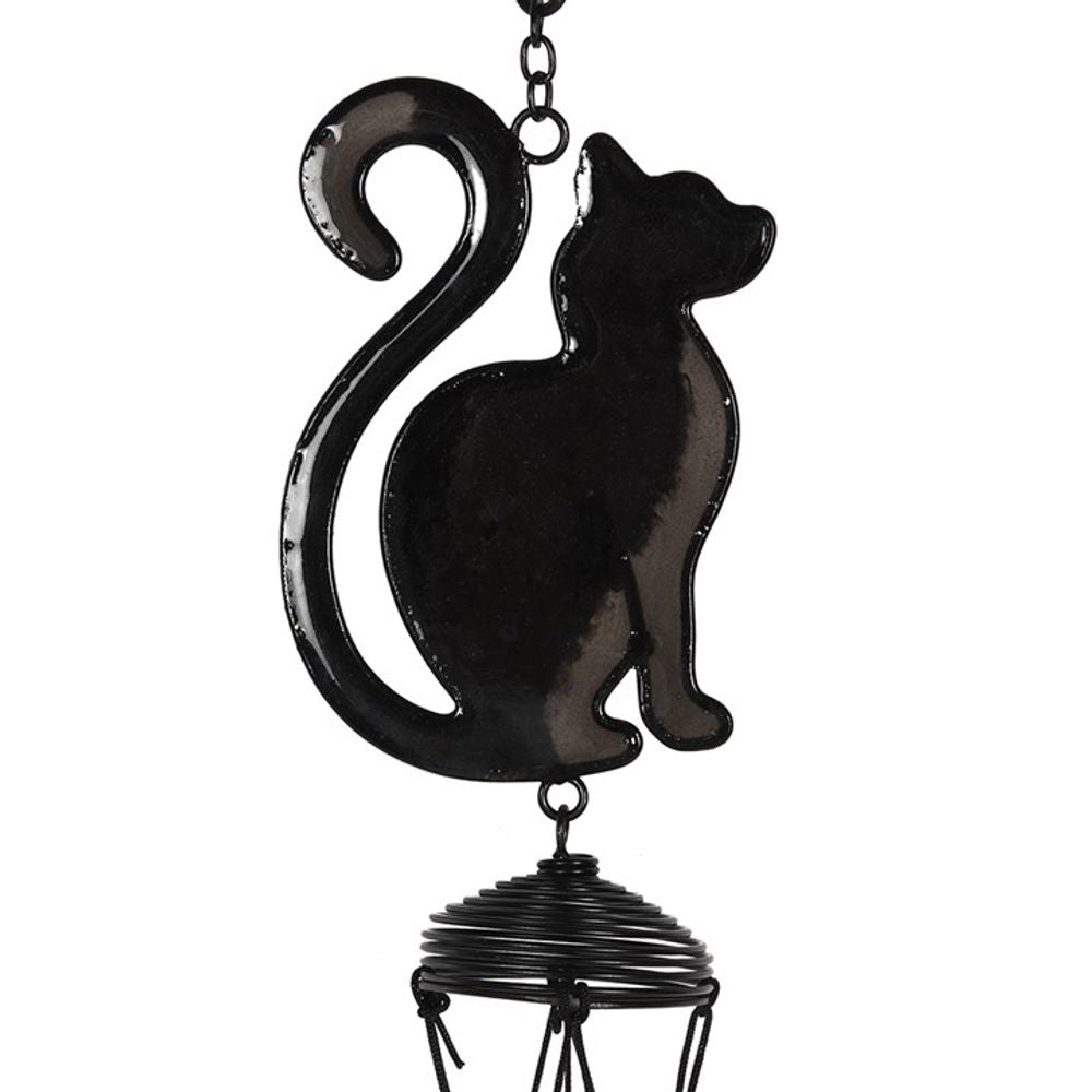 The Black Cat Profile Windchime features a sitting black cat with a curled tail, hanging from a chain. A spiral wire below adds charm—ideal for decorating your outdoor space or gifting to cat lovers.